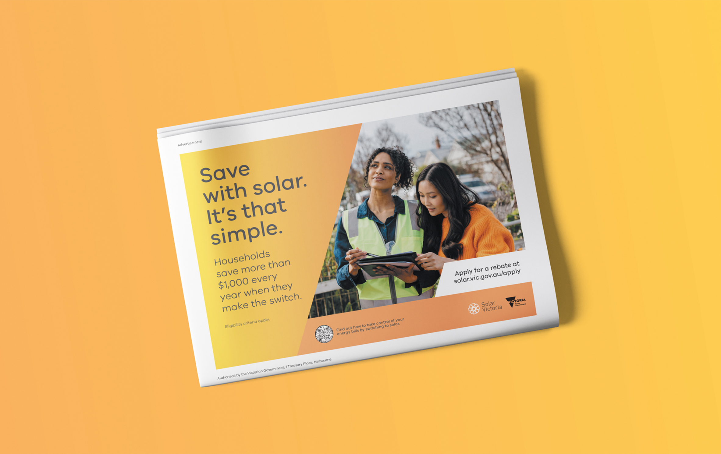 A folded newspaper, displaying a Solar Victoria advertisement. The headline reads "Save with solar. It's that simple."